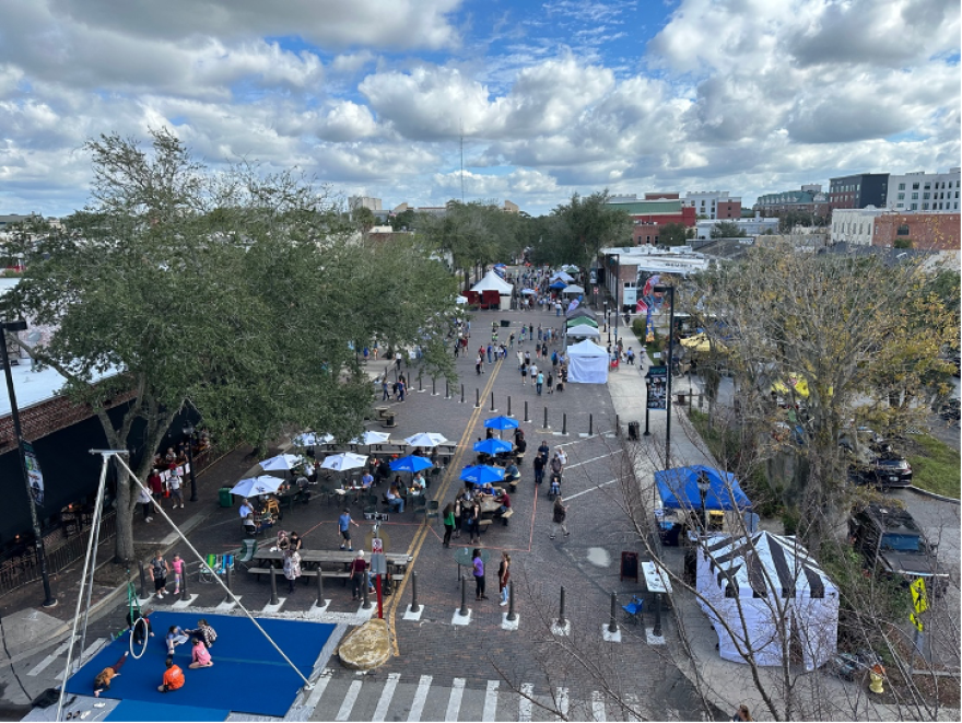 Aerial view of the Downtown Festival and Art Show in Gainesville, FL showcasing colorful tents set up for vendors and attendees enjoying the event.